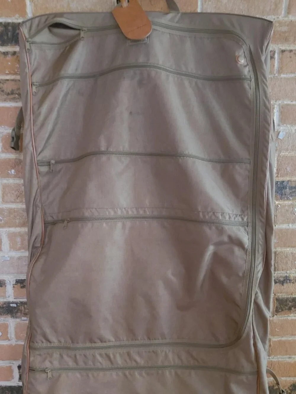 Features 2 deep front pockets with exterior/ interior zipper compartments galore